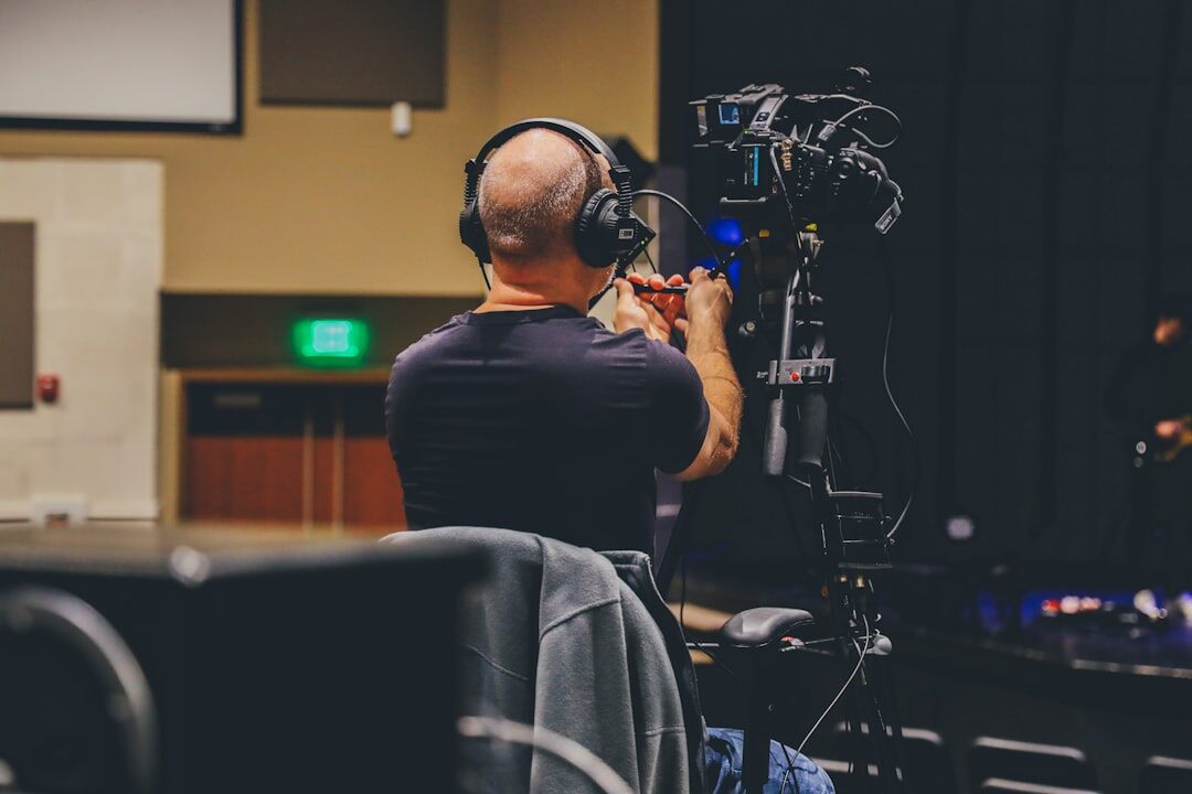 Production coordinator monitoring a wall of live video feeds