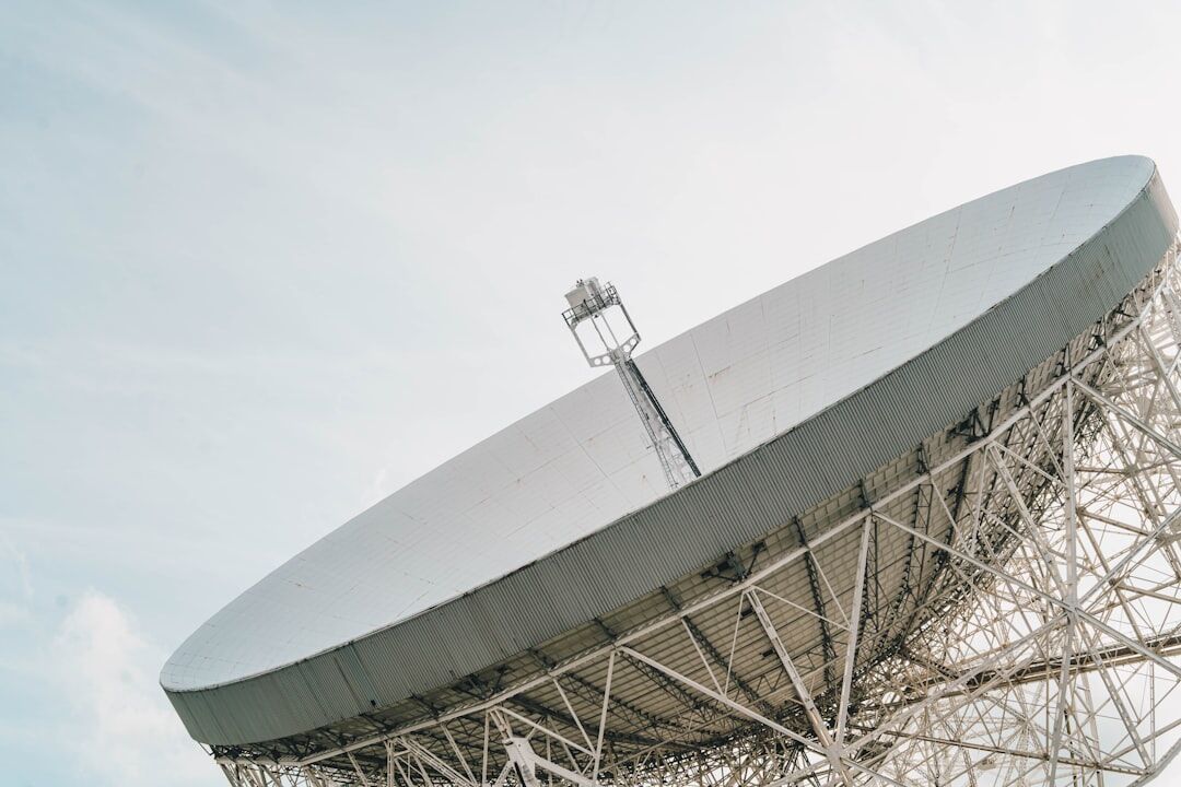 Outside broadcast van parked beside a satellite dish